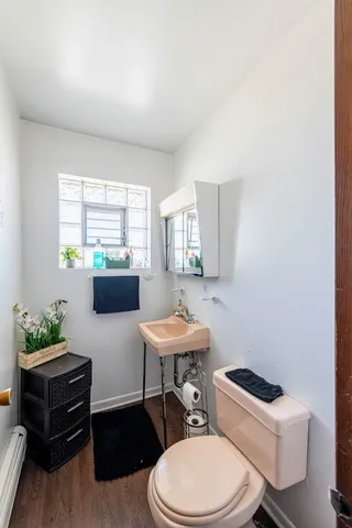 a bathroom with a toilet a sink and a window