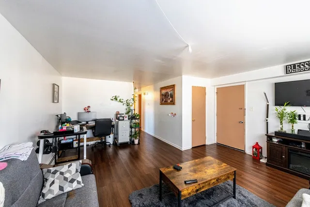 a living room with furniture and wooden floor