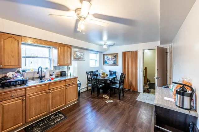 a kitchen with sink cabinets and wooden floor