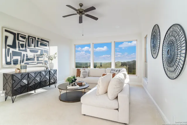 a living room with furniture and a large window