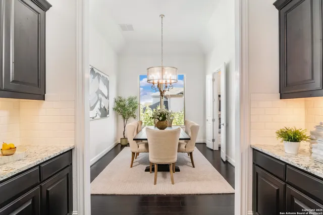a view of a dining room with a table and chairs