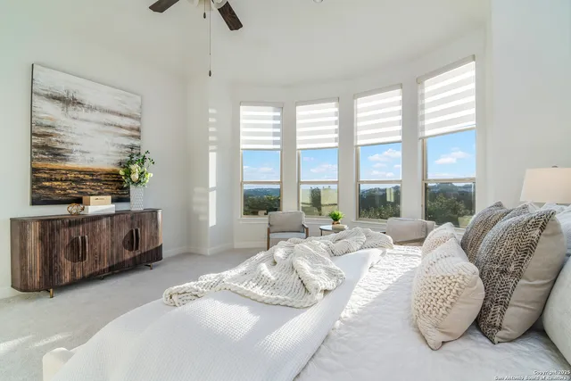 a living room with furniture and a floor to ceiling window