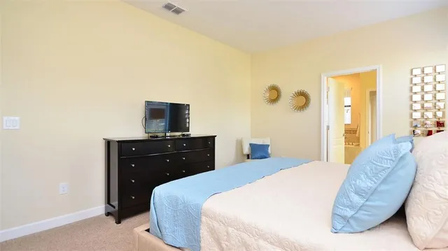 a bedroom with a bed and a flat screen tv