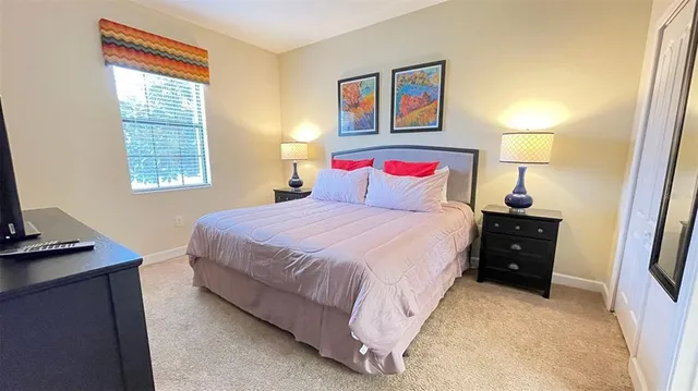 a bedroom with a bed and a desk