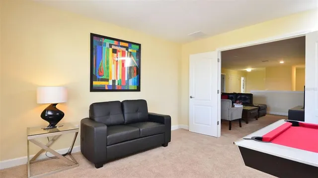 a living room with furniture and a lamp