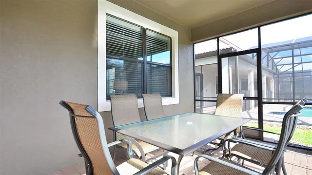 a view of a dining room with furniture and window