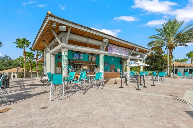 a view of sitting area with chairs and table in patio