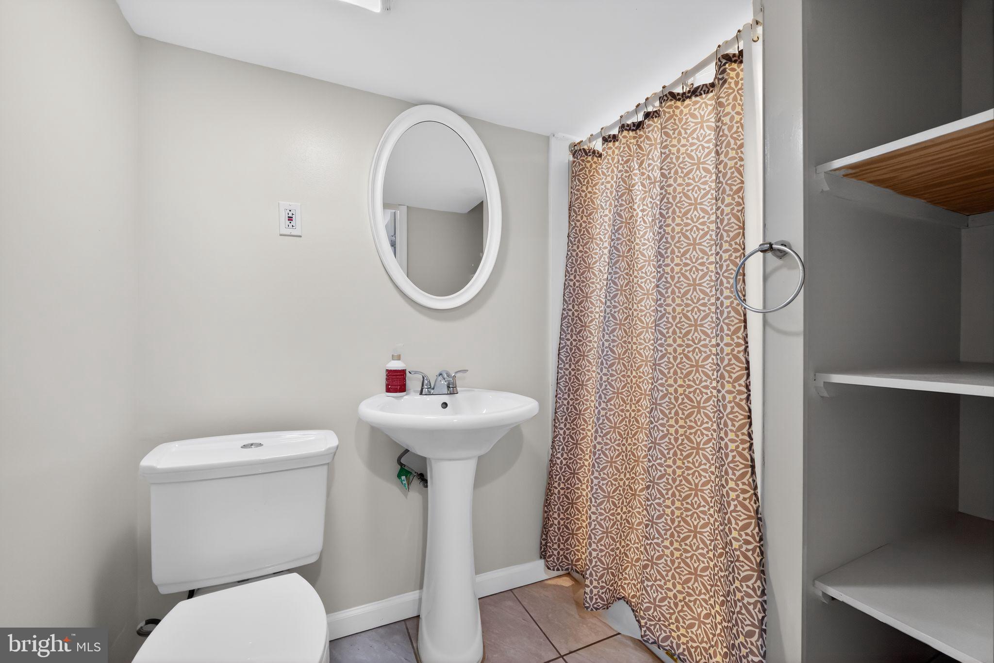 7422 Elizabeth Road Elkins Park, PA 19027 - Photo 24 of 35 a bathroom with a sink toilet and a mirror