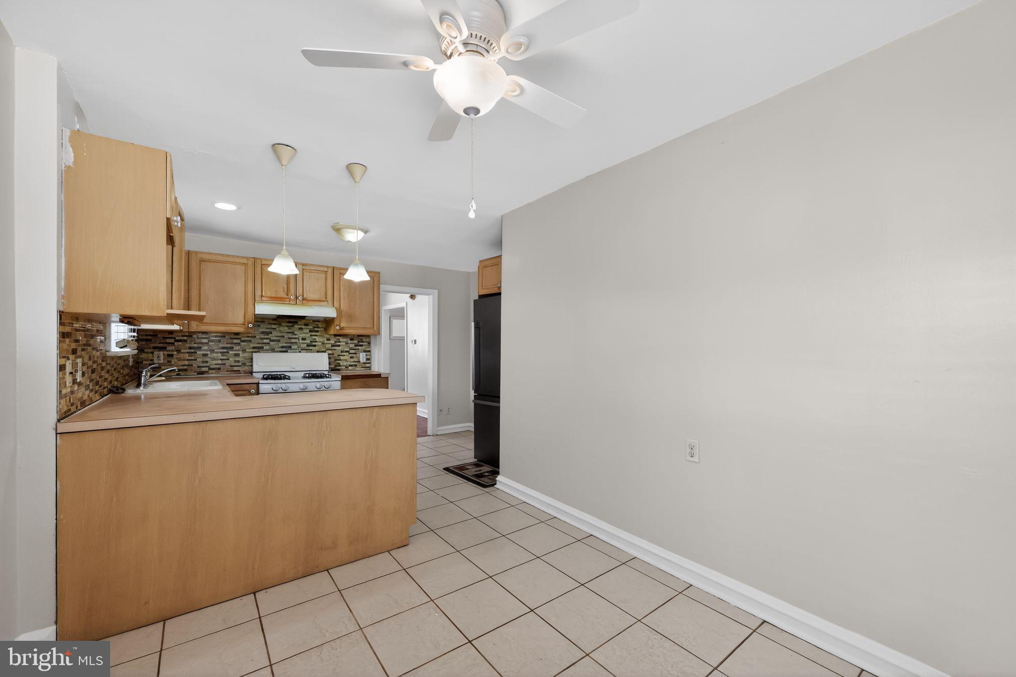 7422 Elizabeth Road Elkins Park, PA 19027 - Photo 6 of 35 a kitchen with stainless steel appliances a refrigerator and a stove top oven