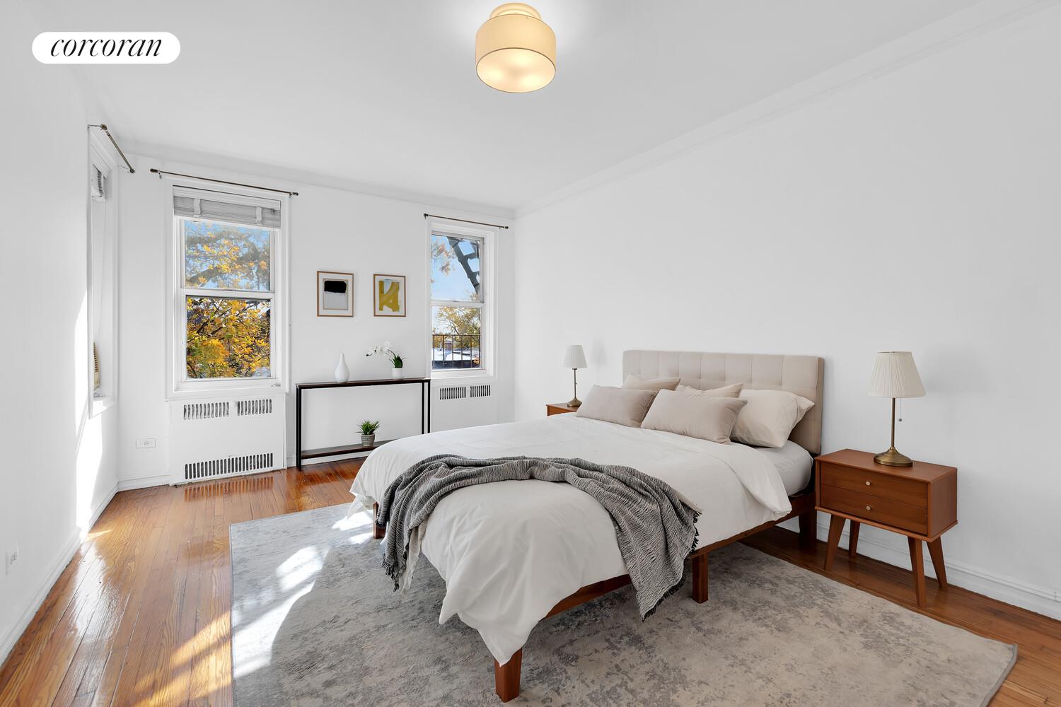 176 Seeley Street, Unit A7 Brooklyn, NY 11218 - Photo 5 of 7 a spacious bedroom with a bed and a window