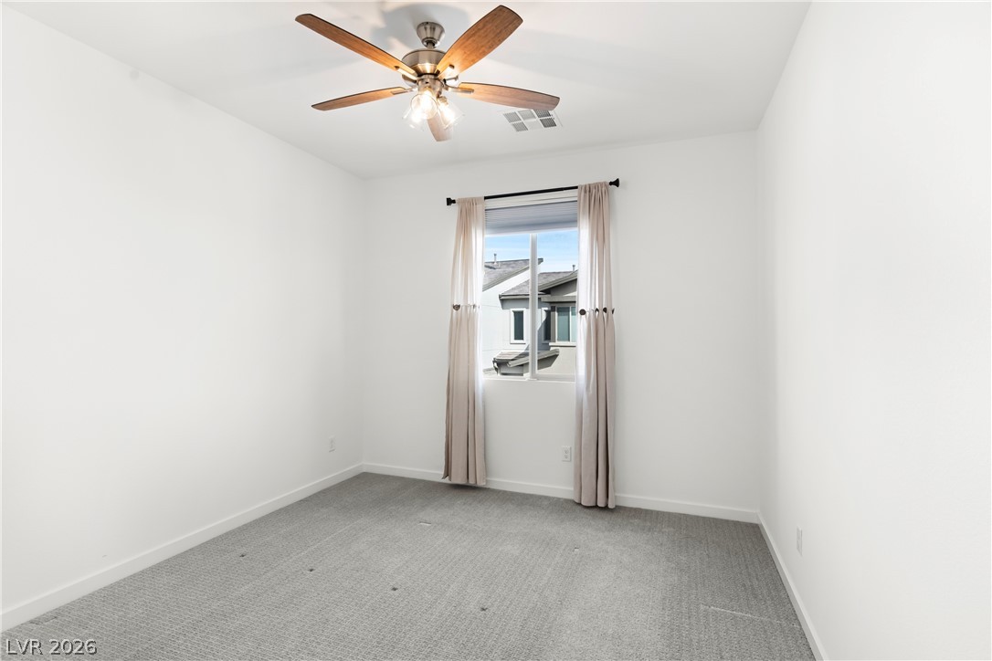 633 Infinity Rdg Street Las Vegas, NV 89138 - Photo 19 of 30 Unfurnished room featuring light colored carpet and ceiling fan