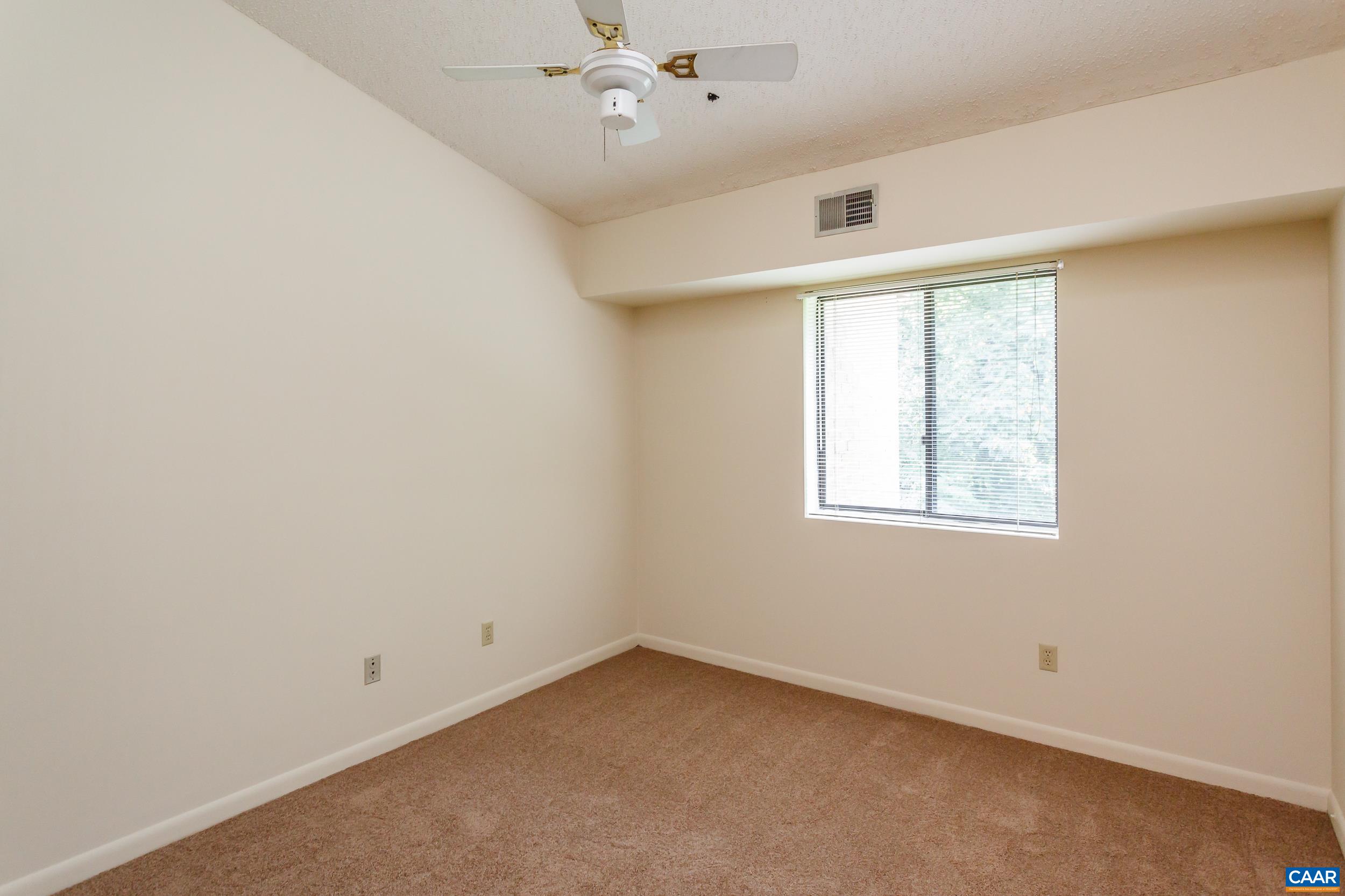 115 Turtle Creek Road, Unit 11 Charlottesville, VA 22901 - Photo 11 of 15 an empty room with a window and ceiling fan