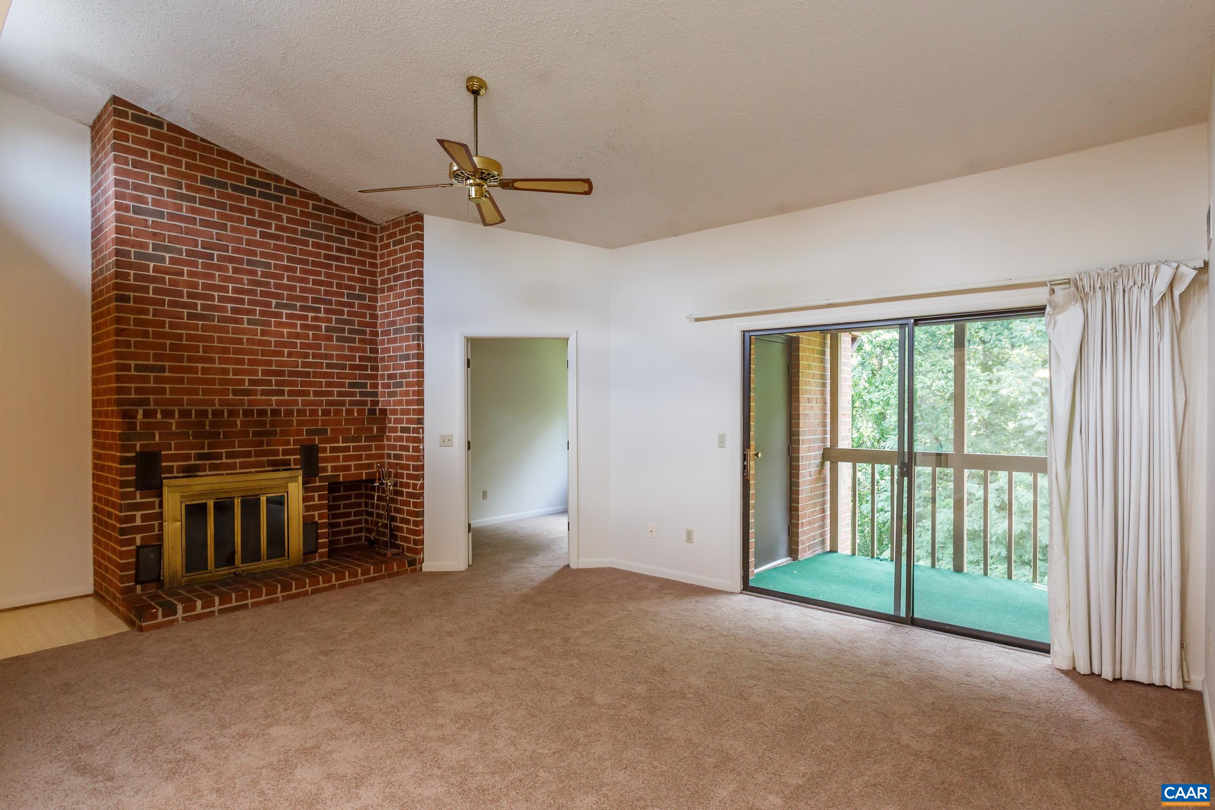 115 Turtle Creek Road, Unit 11 Charlottesville, VA 22901 - Photo 2 of 15 a view of empty room with fireplace and fan