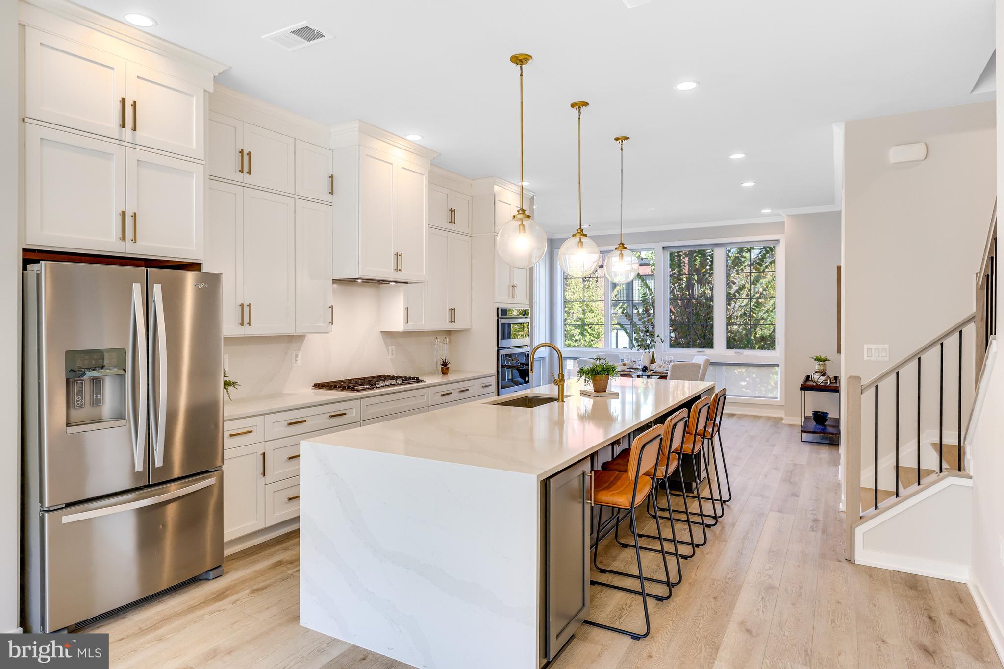 11723 Paysons Way Reston, VA 20191 - Photo 15 of 51 a kitchen with stainless steel appliances granite countertop a sink a stove a refrigerator and island with wooden floor