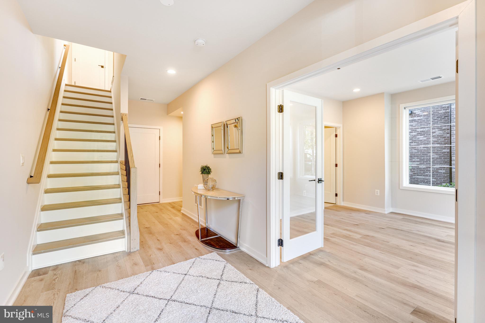 11723 Paysons Way Reston, VA 20191 - Photo 6 of 51 a view of a livingroom with wooden floor and white walls