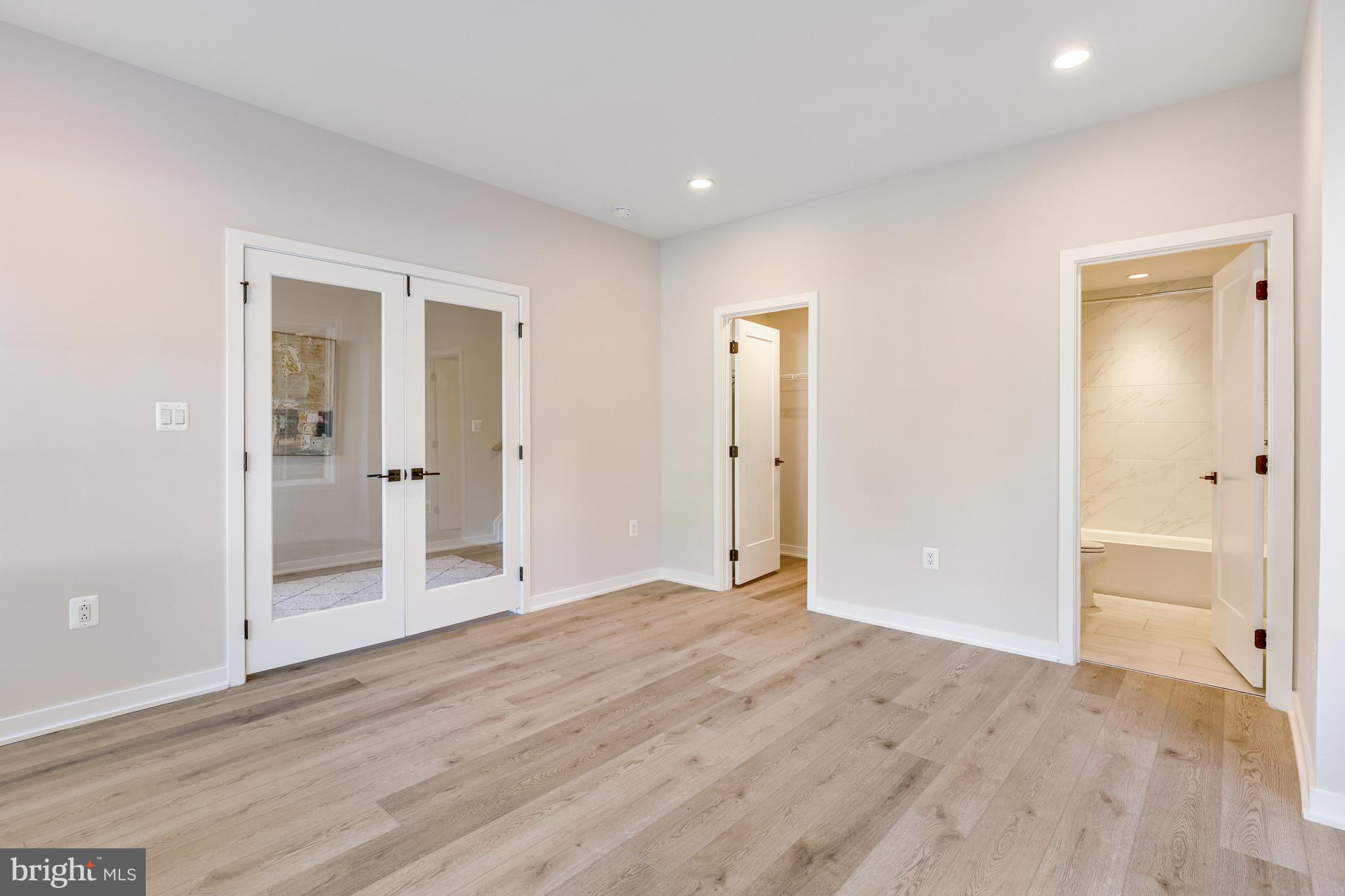 11723 Paysons Way Reston, VA 20191 - Photo 8 of 51 wooden floor in an empty room with wooden door