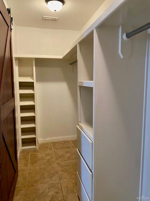 1220 Eva Street Edinburg, TX 78539 - Photo 13 of 21 a view of walk in closet with empty racks