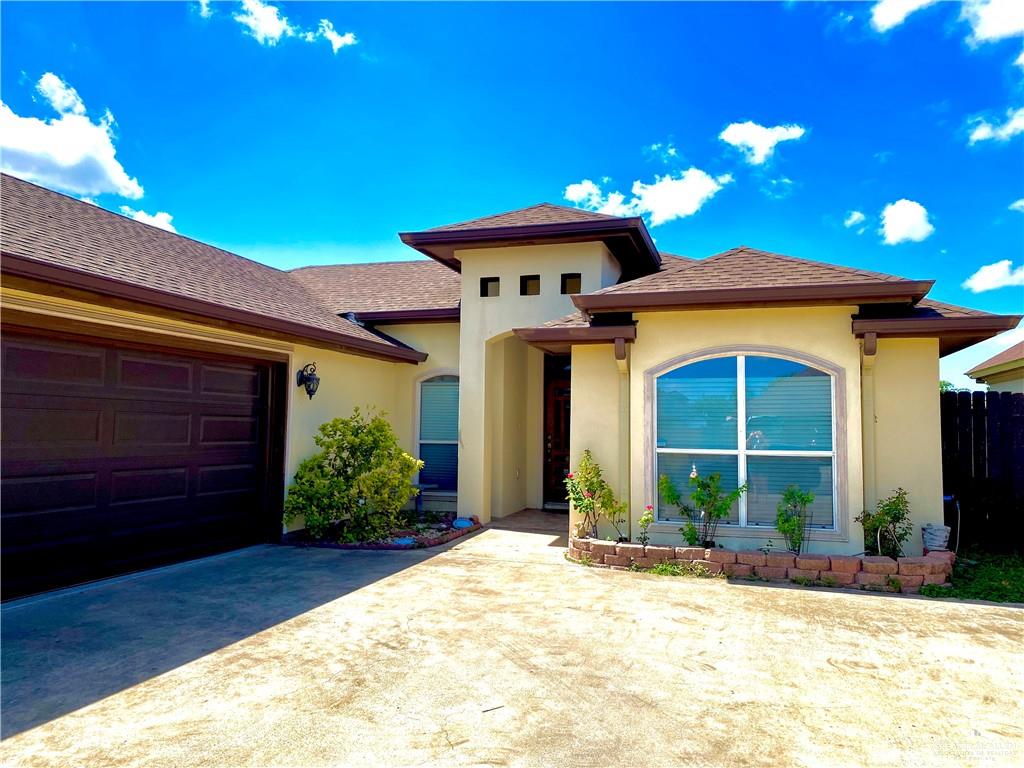 1220 Eva Street Edinburg, TX 78539 - Photo 2 of 21 a front view of a house with a yard