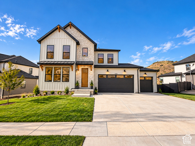 1595 West Canyon Rim Road, Unit 630 Lehi, UT 84048 - Photo 1 of 41 Modern exterior featuring board and batten siding with stone accents. Lighting enhanced with ai.
