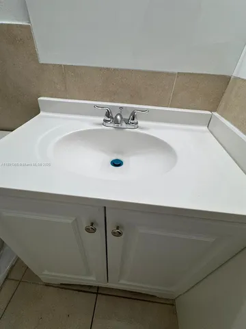 a white toilet sitting next to a bathroom sink