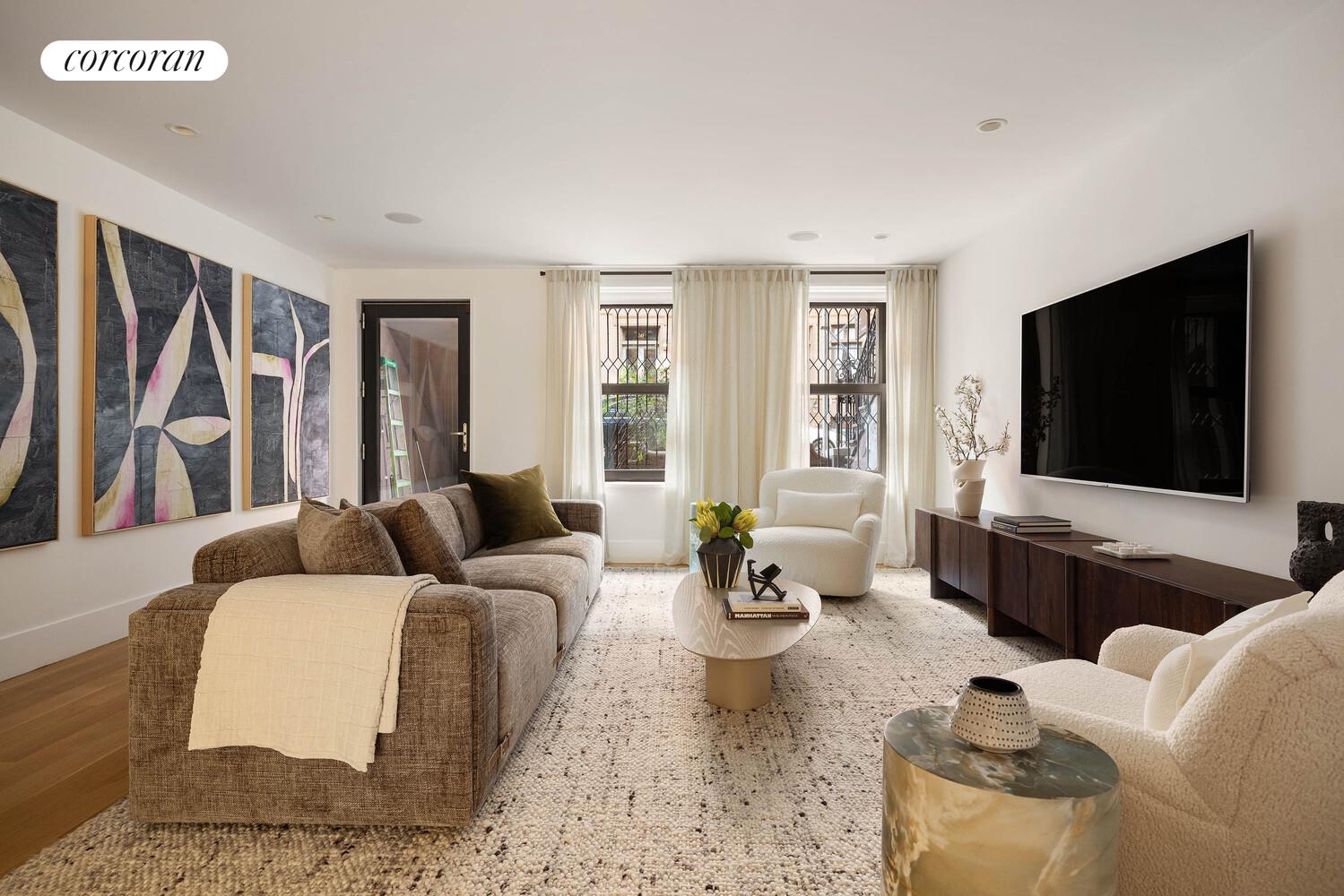 53 West 71st Street Manhattan, NY 10023 - Photo 17 of 41 a living room with furniture and a flat screen tv