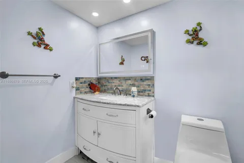 a bathroom with a sink a vanity and a mirror