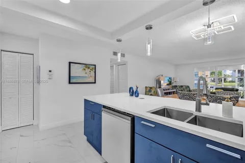 a kitchen with a sink and a refrigerator