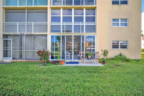 a front view of a house with a yard and sitting area