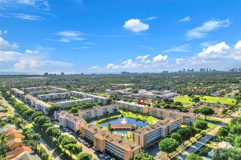 an aerial view of residential houses with outdoor space and ocean view