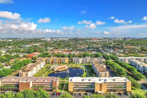 an aerial view of residential houses with city view