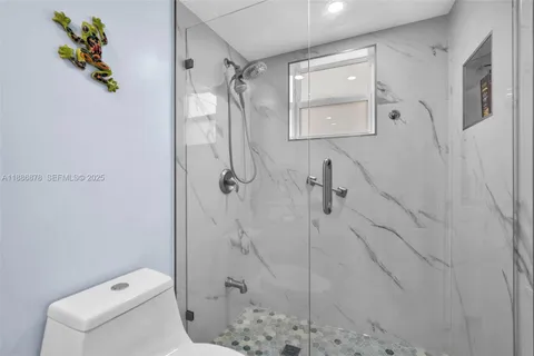 a bathroom with a shower a toilet and sink