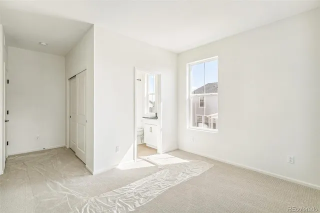 a view of a bedroom with a bed and a window