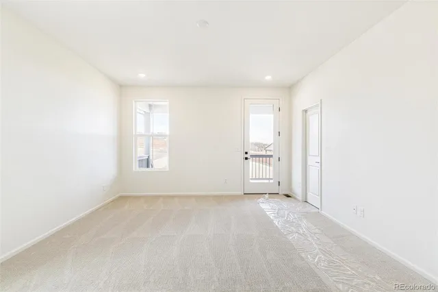 a view of a livingroom with a kitchen space with a sink