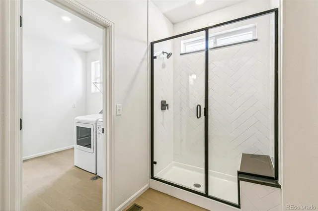 a bathroom with a glass shower door
