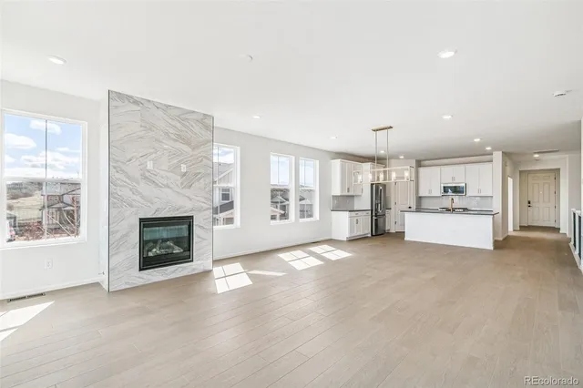 a view of a kitchen with a sink and a fireplace