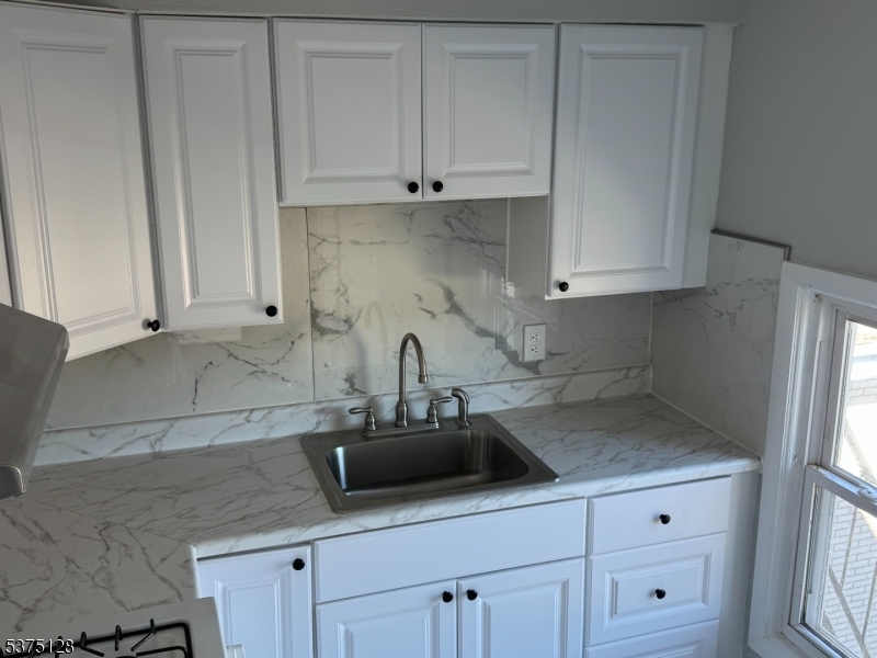 183 Main Street Hackettstown, NJ 07840 - Photo 2 of 12 a kitchen with white cabinets and a sink