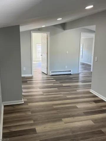 a view of room with window and wooden floor