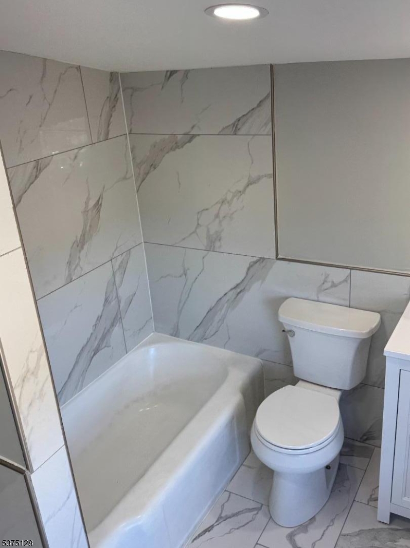 183 Main Street Hackettstown, NJ 07840 - Photo 10 of 12 a bathroom with a toilet and a bathtub