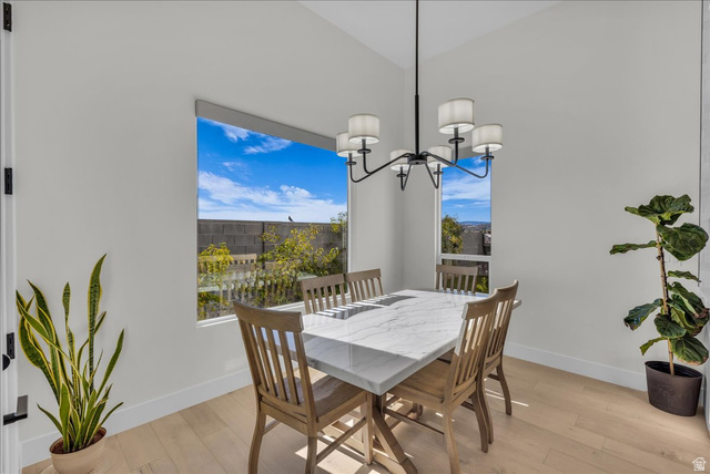 404 North Marsala Way St. George, UT 84770 - Photo 7 of 26 Dining space with light wood-style floors, lofted ceiling, and suspended lighting