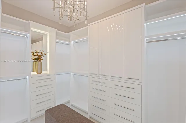 a living room with furniture a chandelier and a wooden floor