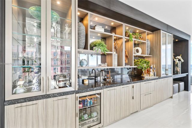 a view of an empty room with wooden floor and windows
