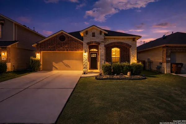 a front view of a house with a yard