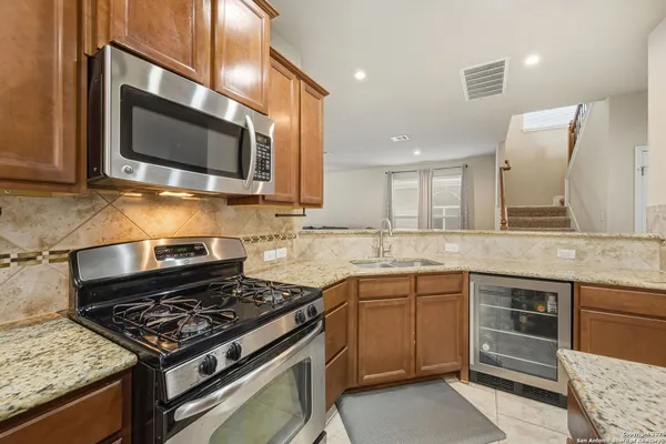 a kitchen with stainless steel appliances granite countertop a stove and cabinets