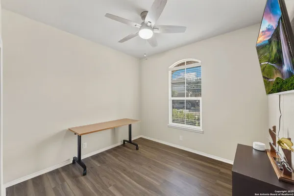 a view of a livingroom with a ceiling fan and window