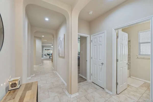 a view of a hallway with wooden floor and bathroom