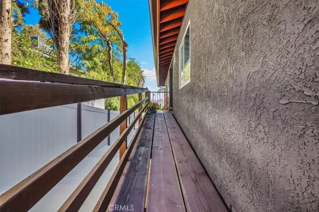 a living room with furniture a flat screen tv and a window