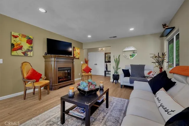 a kitchen with granite countertop a refrigerator cabinets and wooden floor
