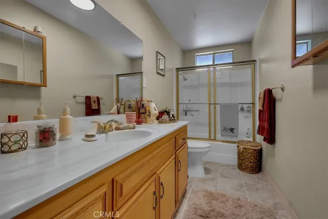 a living room with furniture and a ceiling fan