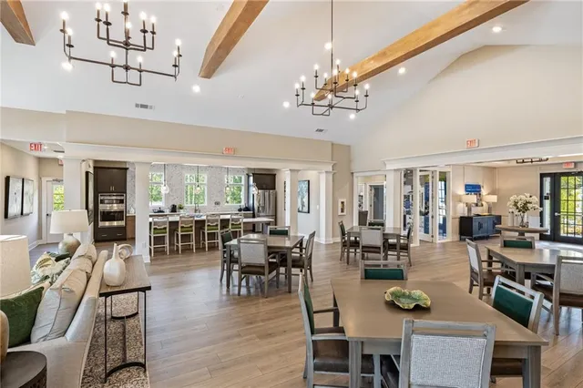 a view of a dining room with furniture wooden floor and chandelier