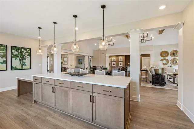 a view of a kitchen and kitchen island the wooden floor